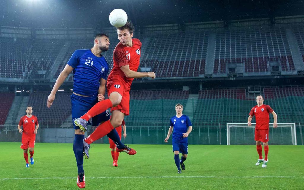 A photo of a red team vs blue team soccer match to illustrate the cybersecurity concept of pitting the two teams against each other